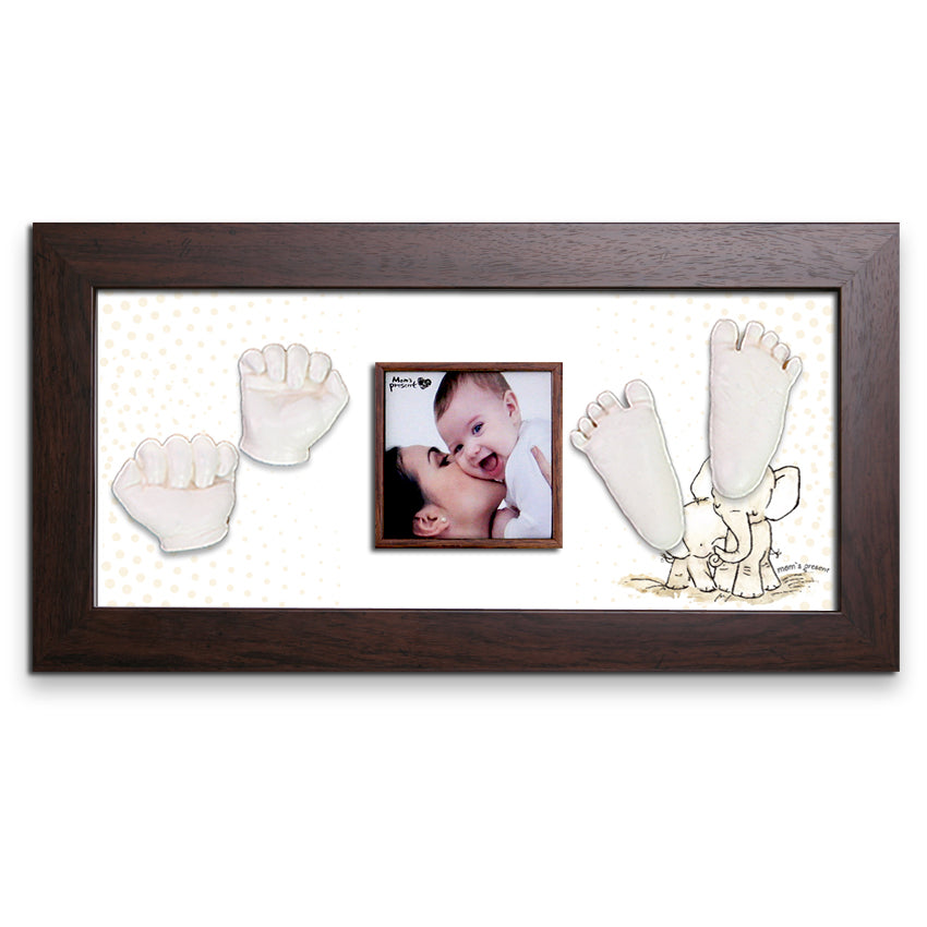 A luxury LOVE MOM'S PRESENT Momspresent Baby Hands and Foot 3D Casting Print DIY Kit with Walnut Frame8-Elephant-Hug showcasing a photograph of a woman kissing a smiling baby, flanked by plaster casts from the kit of tiny hands on the left and adorable feet on the right. The background features a subtle pattern with a cute illustration of an elephant under the feet casts—truly LOVE MOM’S PRESENT.